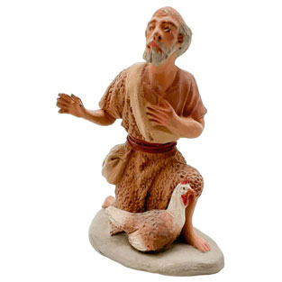 Pastor en barro adorando gallina